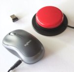 Gray computer mouse next to a nano USB transceiver and red switch button.