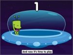 Alien in UFO with subtitle below that reads, "And now it's time to play."
