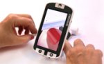 4.3" camera magnifier with close up of red-painted fingernail and filer on screen.