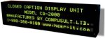 Angled view of black, horizontal rectangular device with green computer screen text displayed in four rows.
