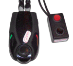 Two black components with cords attached. One is larger and more oval-shaped; the second is small and rectangular, with a red button.