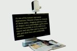MultiView HD magnifying text from a magazine on to the monitor. The text is yellow on a black background.