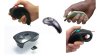 Various models of handheld trackball mice. All are small, hand-sized devices that resemble a combination of a laser-pointer, remote control, and Star Trek-style "Phaser." They are curved to fit the hand, and some feature a loop to place your finger into while holding. All of them include a small trackball on the top, and two click buttons on either side of the trackball. Three of the four mice are grey or black; one mouse is white, green and yellow and features a much thinner profile.