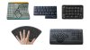 Various models of one-handed keyboards. Two models are small and rectangular and feature twelve rows of letter keys, each with secondary functions marked at the bottom, which are activated using "shift" or other modifiers. Another model resembles a large, square, white box with a curved keyboard layout (accessible with only one hand) on the right side and numeric/function keys on the left. The fourth is similar to a standard keyboard, but the letters arranged in a circle. The fifth model is fan-shaped.