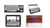  Various models of keyguards. They are rigid overlays that lay on top a keyboard or screen and fill the gaps in between keys on a keyboard, stabilizing them. One model is clear; one is black, and another is red. Two models fit a touchscreen tablet and frame out where keyboard keys will appear on the screen. One model fits a full-sized desktop keyboard, while another fits atop a laptop keyboard.