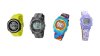 Several different models of vibrating watches. They resemble standard digital wristwatches. One is black, one is yellow, another is multi-colored, and the fourth is lavender.