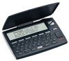A medium-sized, black device resembling a Braille notetaker with a hinged cover that folds down. There is an LCD display panel at the top, and underneath it, there is a QWERTY keyboard and various menu buttons.